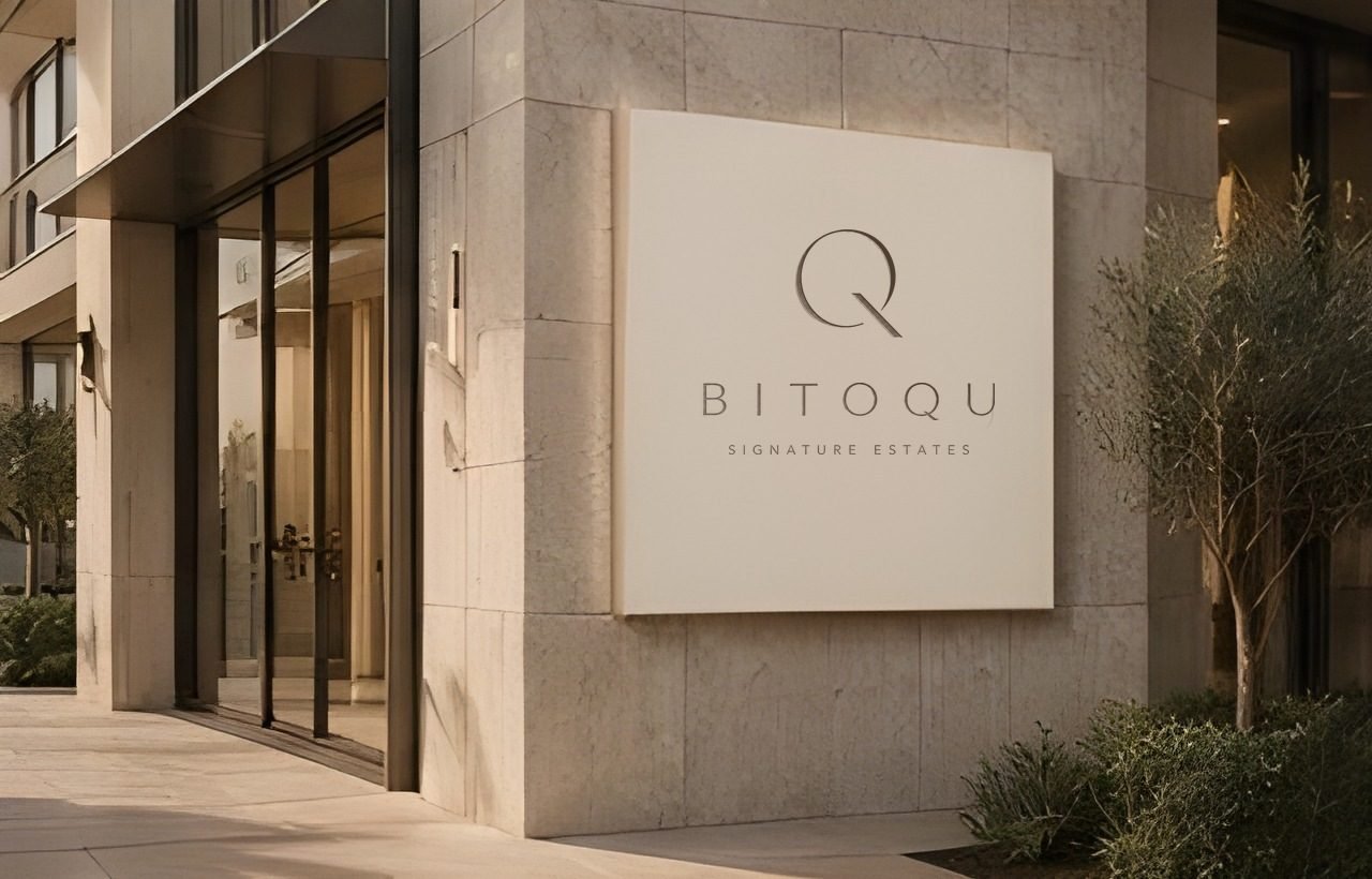 Вывеска BITOQU Signature Estates на фасаде из известняка